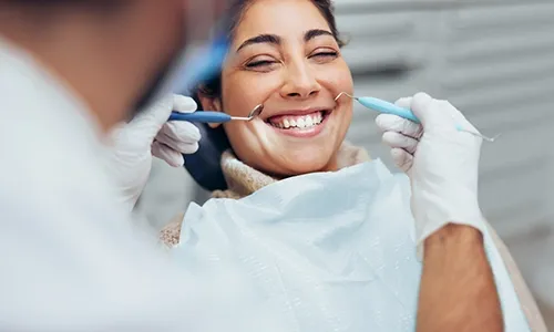Smiling woman in a dental chair during an exam